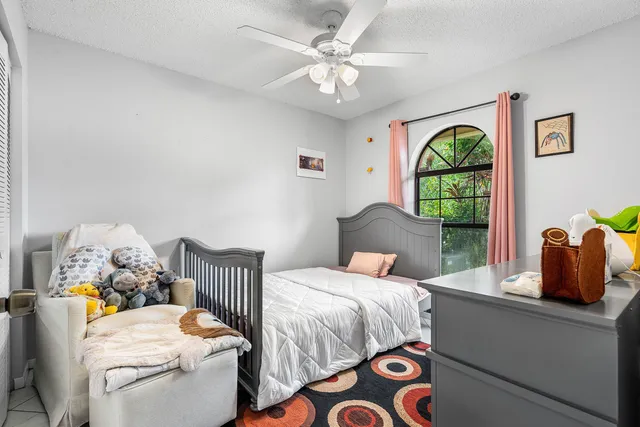 a bedroom with a bed and a painting on the wall