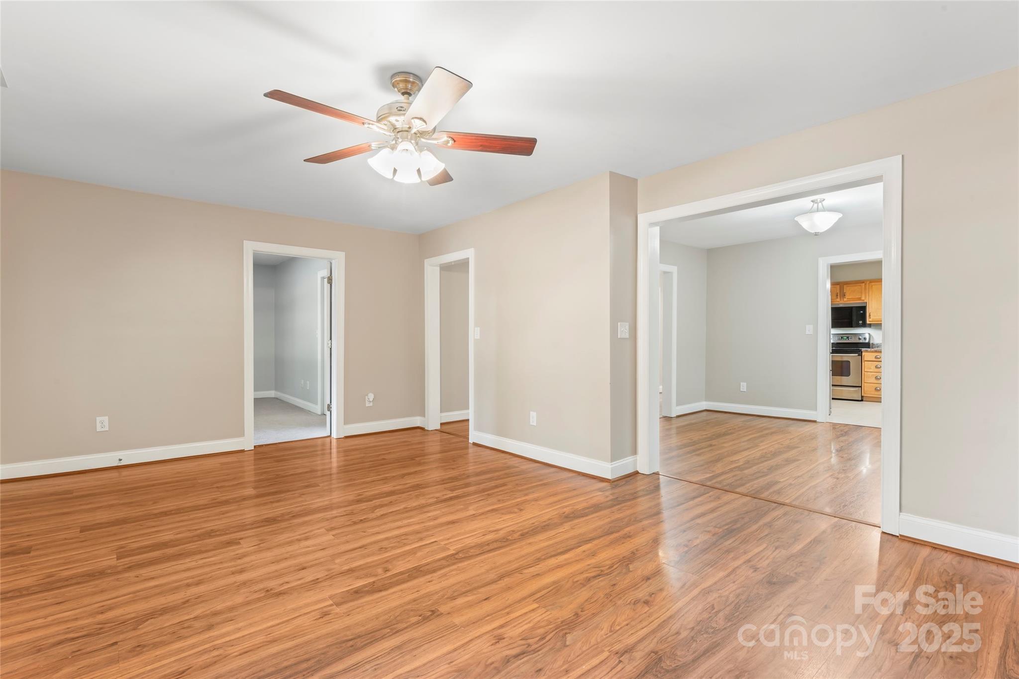 8450 Red Road Rockwell, NC 28138 - Photo 12 of 48 a view of an empty room with wooden floor and a ceiling fan