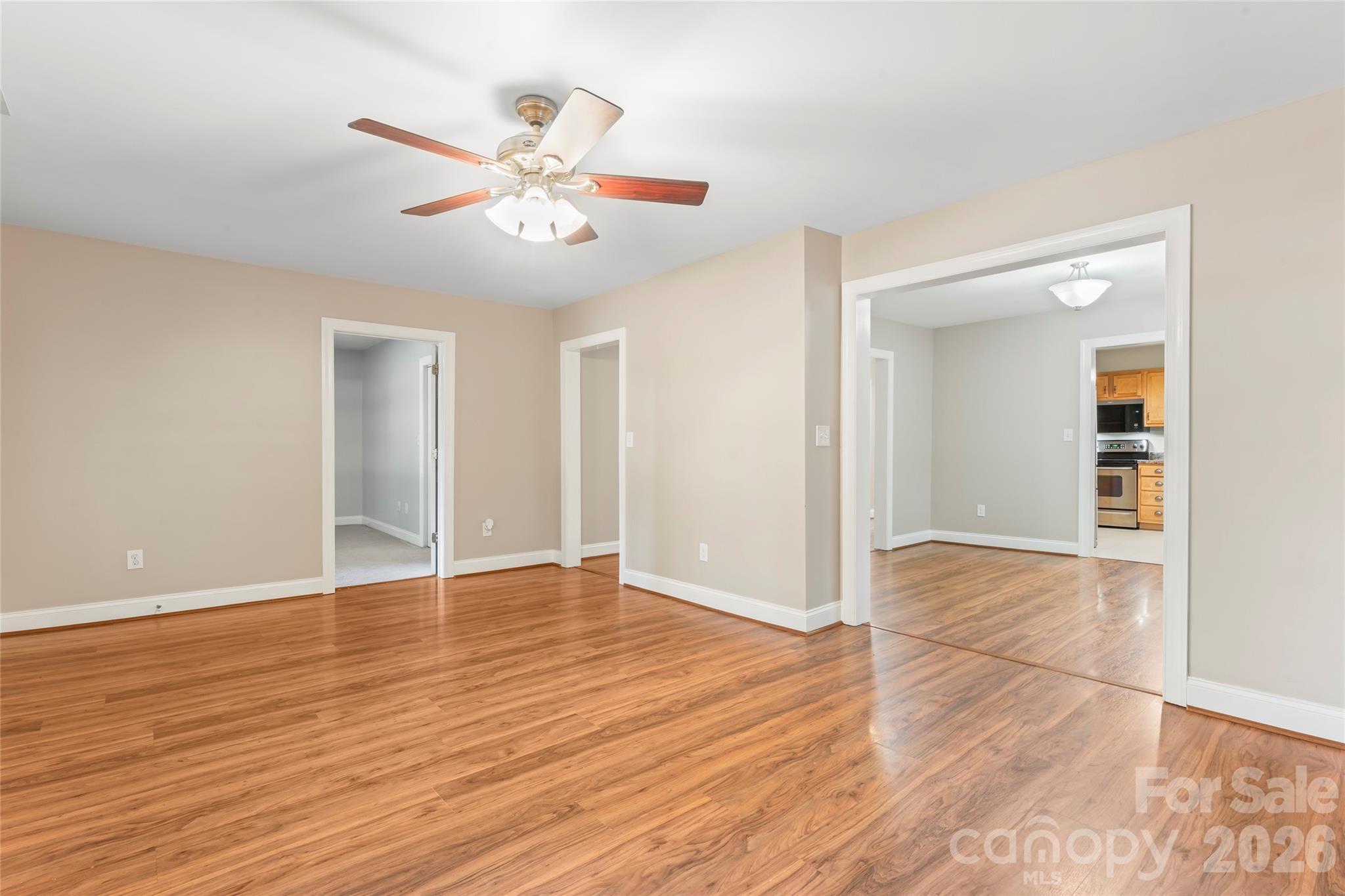 8450 Red Road Rockwell, NC 28138 - Photo 12 of 48 a view of an empty room with wooden floor and a ceiling fan