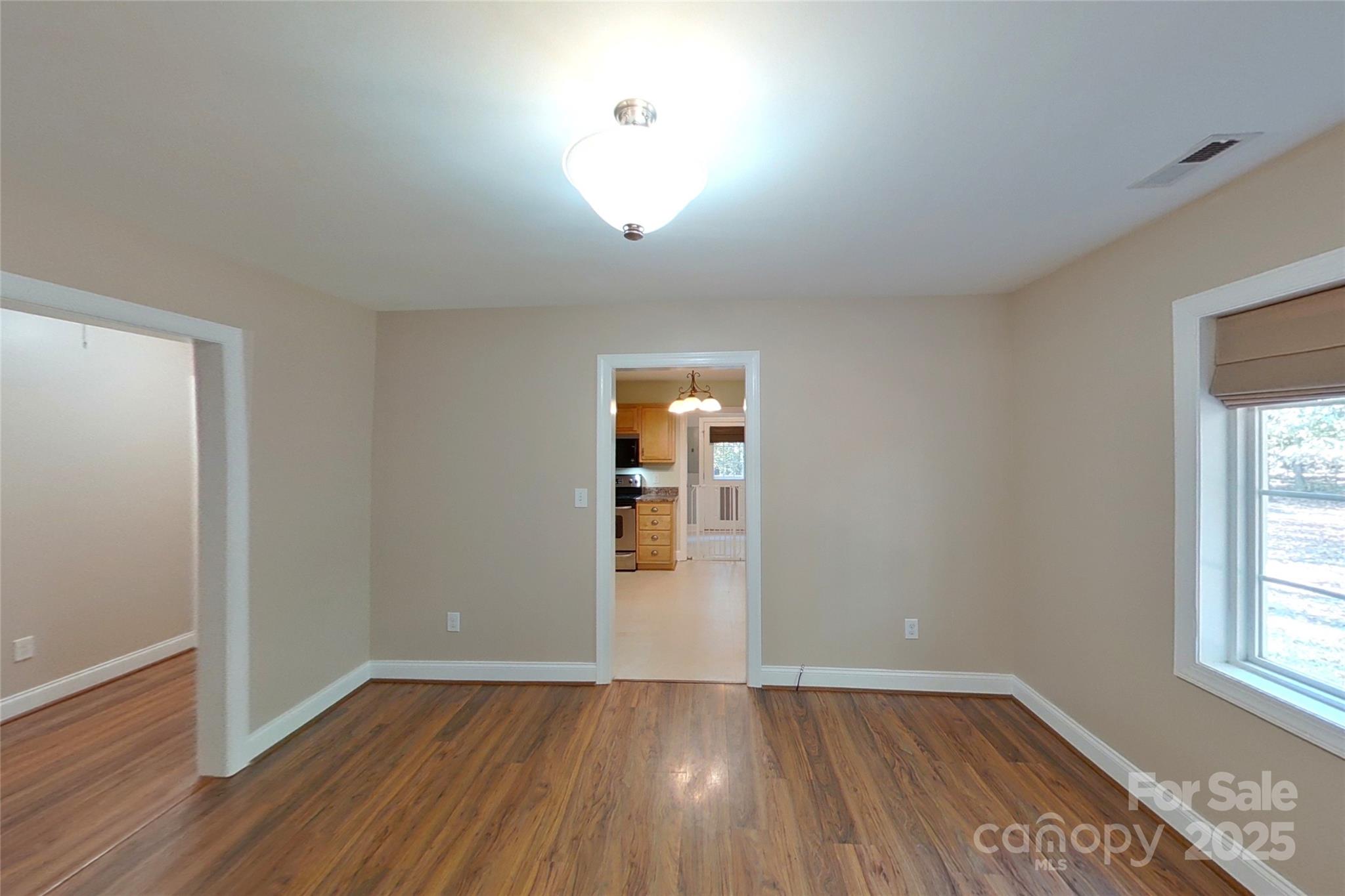 8450 Red Road Rockwell, NC 28138 - Photo 20 of 48 an empty room with wooden floor and windows
