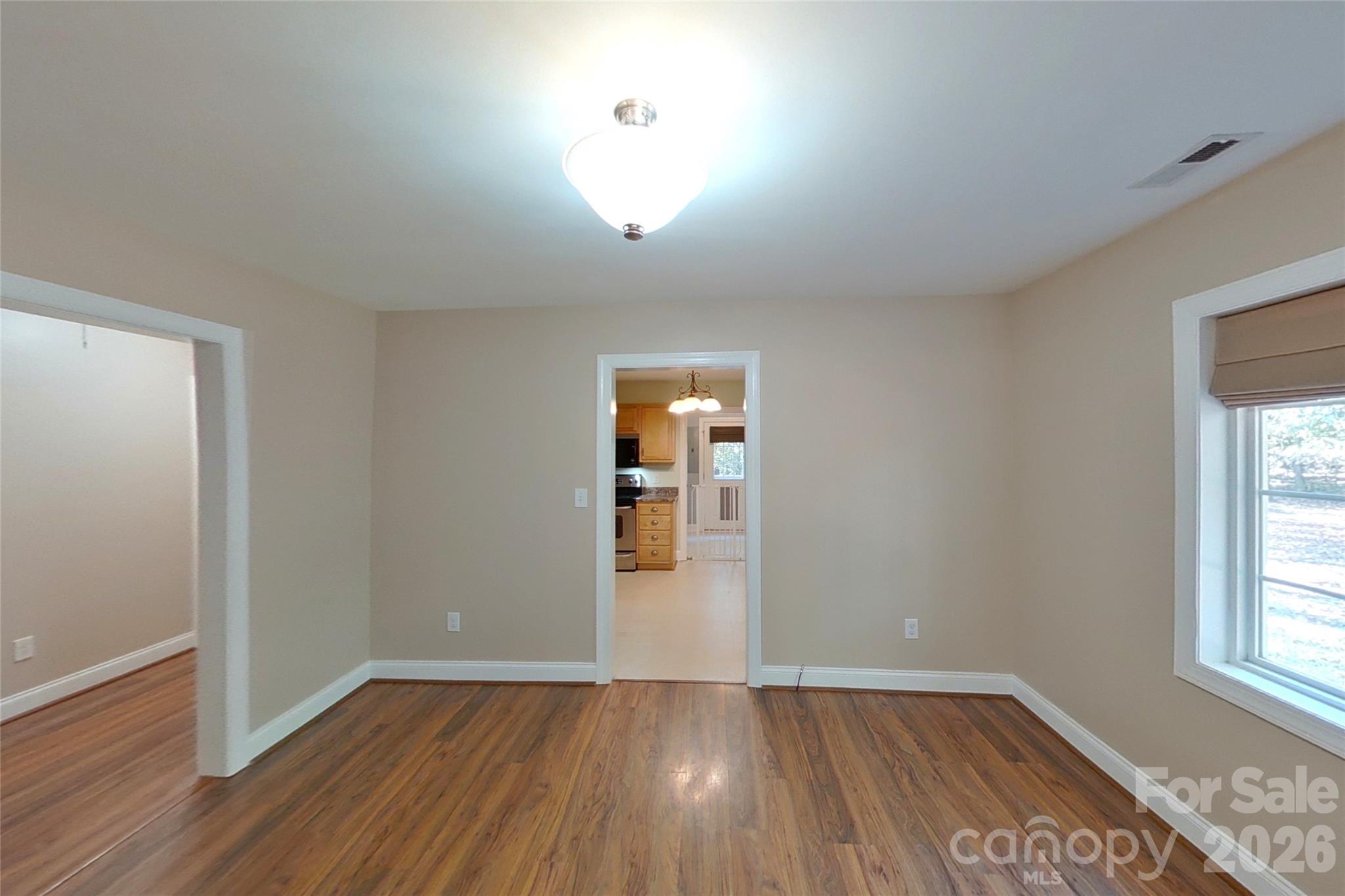 8450 Red Road Rockwell, NC 28138 - Photo 20 of 48 an empty room with wooden floor and windows