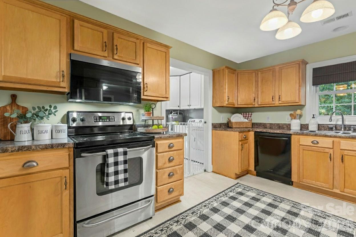 8450 Red Road Rockwell, NC 28138 - Photo 21 of 48 a kitchen with stainless steel appliances granite countertop a stove a sink and a microwave