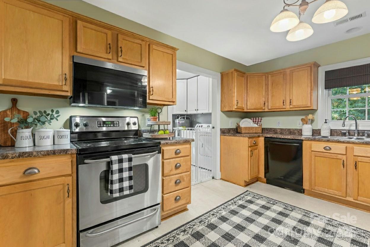 8450 Red Road Rockwell, NC 28138 - Photo 21 of 48 a kitchen with stainless steel appliances granite countertop a stove a sink and a microwave