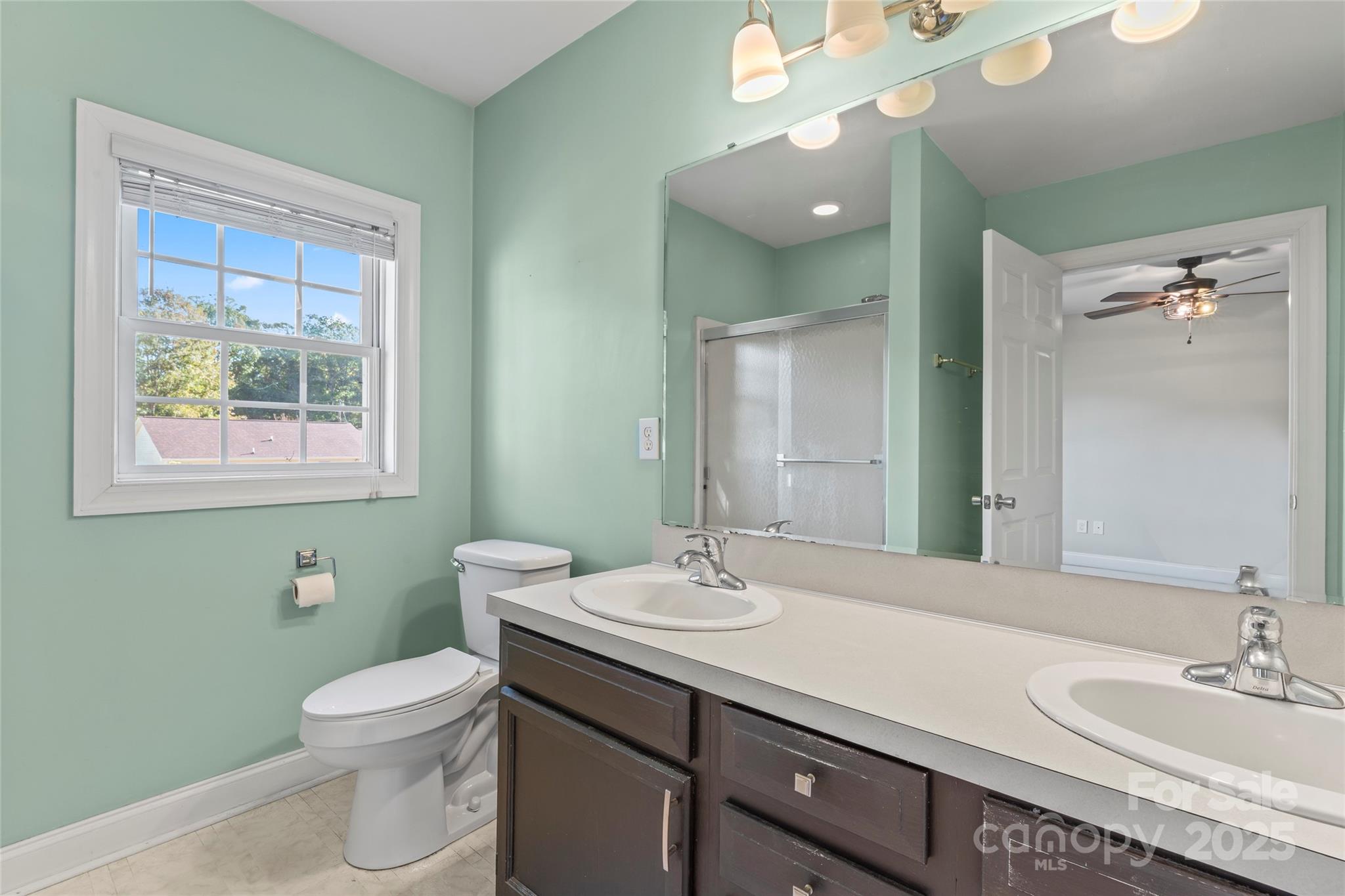 8450 Red Road Rockwell, NC 28138 - Photo 29 of 48 a bathroom with a toilet a sink and mirror