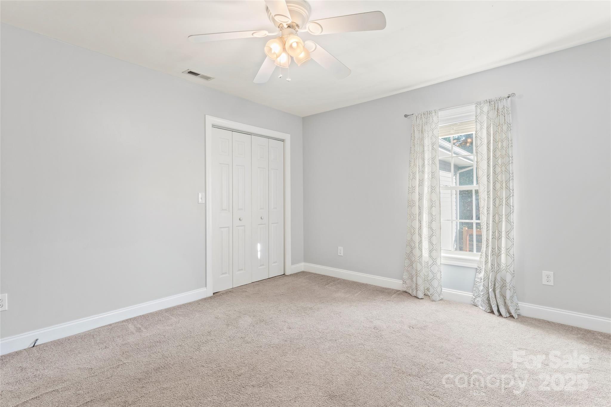 8450 Red Road Rockwell, NC 28138 - Photo 32 of 48 an empty room with a ceiling fan and a window