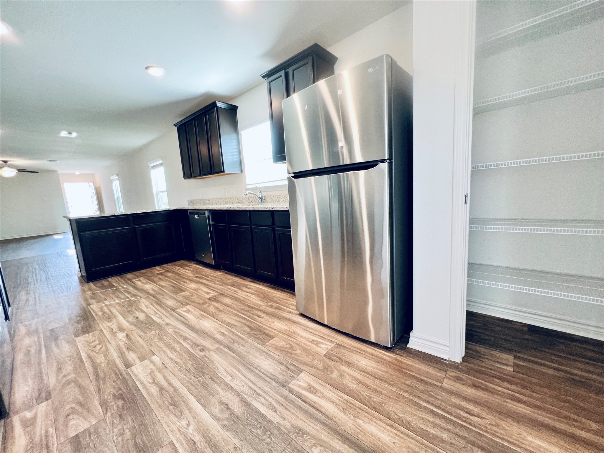 520 Locksley Cove Jarrell, TX 76537 - Photo 7 of 27 A well-appointed kitchen showcasing contemporary finishes and practical pantry storage.