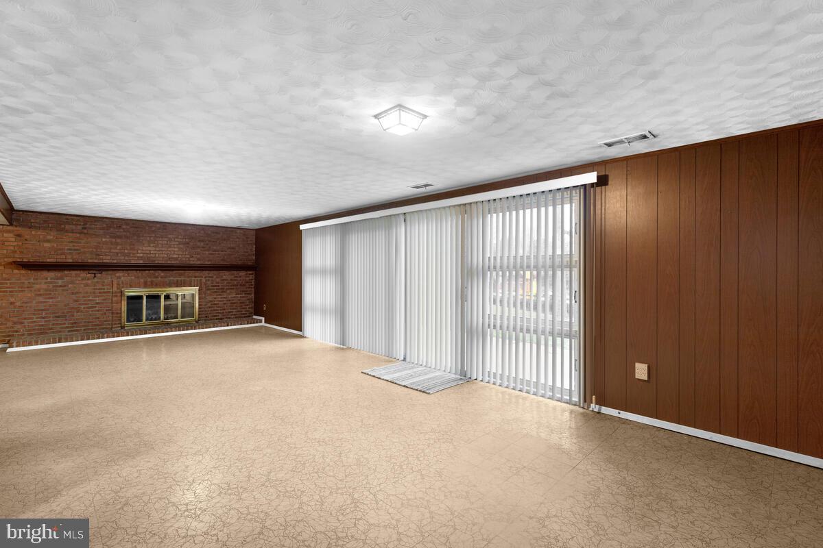 2725 Woodedge Road Silver Spring, MD 20906 - Photo 23 of 36 Family Room with fireplace and slider to yard