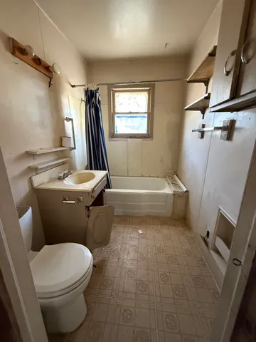 a white toilet sitting next to a bathroom sink