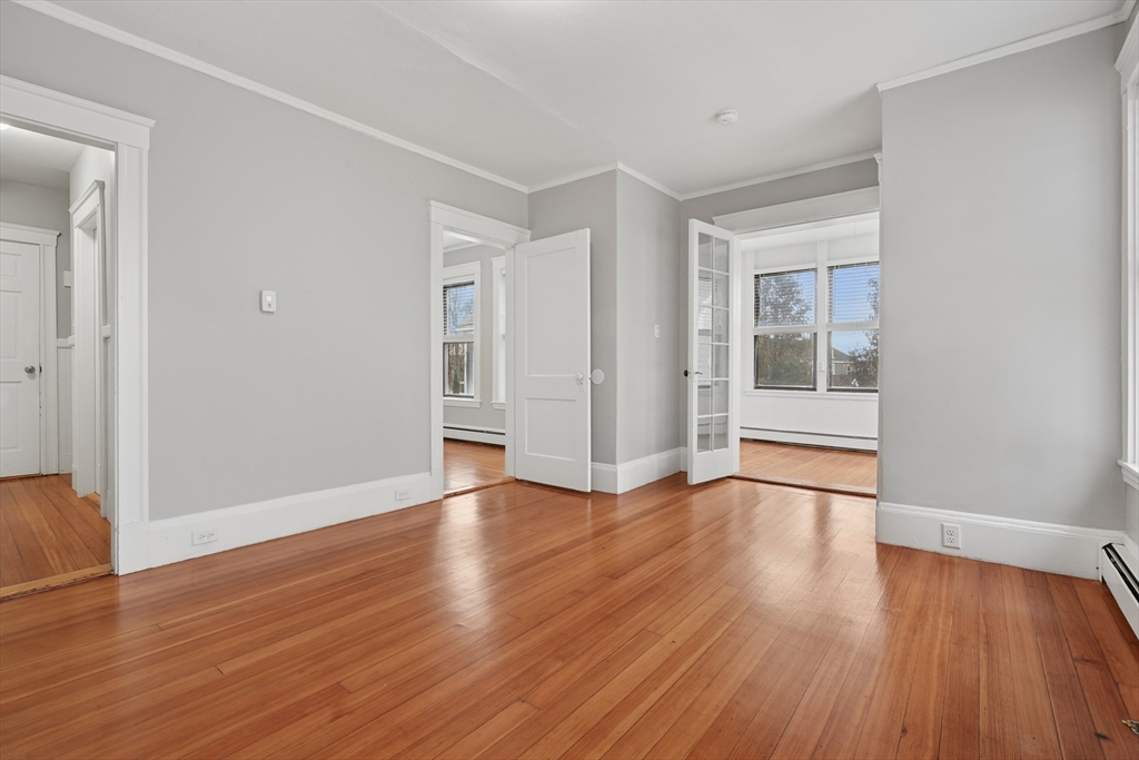 55 Summer Street, Unit 1 Haverhill, MA 01830 - Photo 11 of 13 a view of an empty room with wooden floor and a window