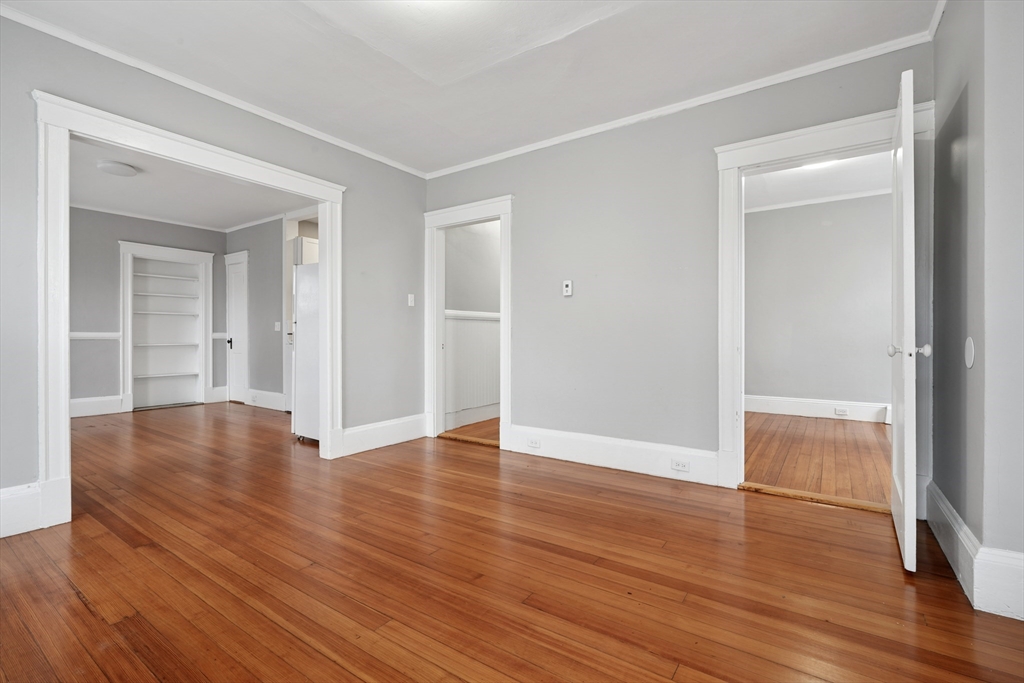 55 Summer Street, Unit 1 Haverhill, MA 01830 - Photo 6 of 13 wooden floor in an empty room with a window