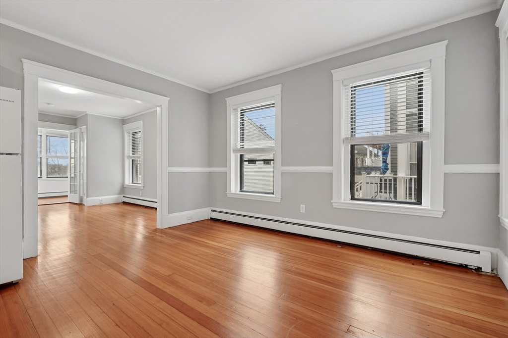 55 Summer Street, Unit 1 Haverhill, MA 01830 - Photo 9 of 13 a view of an empty room with wooden floor and windows