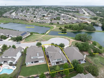 an aerial view of lake residential houses with outdoor space and swimming pool