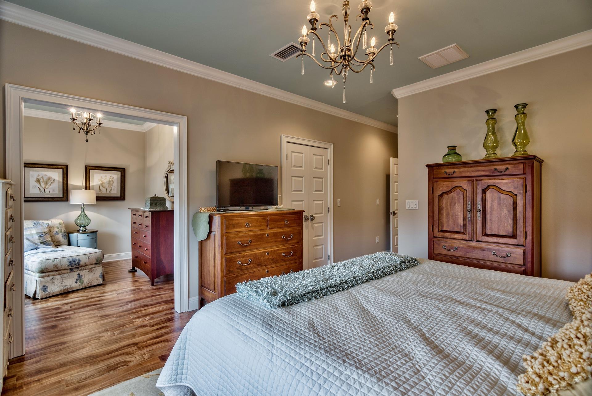 1976 Baytowne Loop Miramar Beach, FL 32550 - Photo 13 of 23 a bedroom with a bed and a chandelier