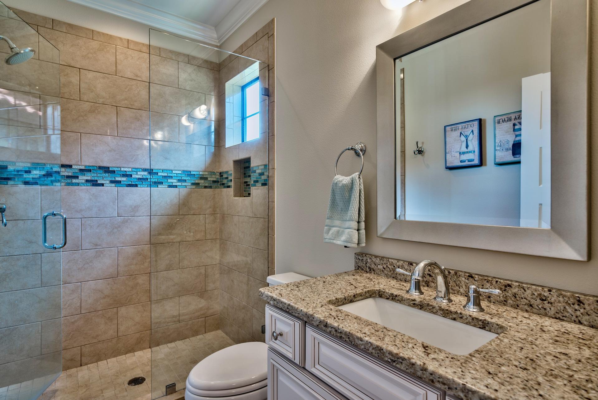 1976 Baytowne Loop Miramar Beach, FL 32550 - Photo 18 of 23 a bathroom with a granite countertop sink a toilet a mirror and shower