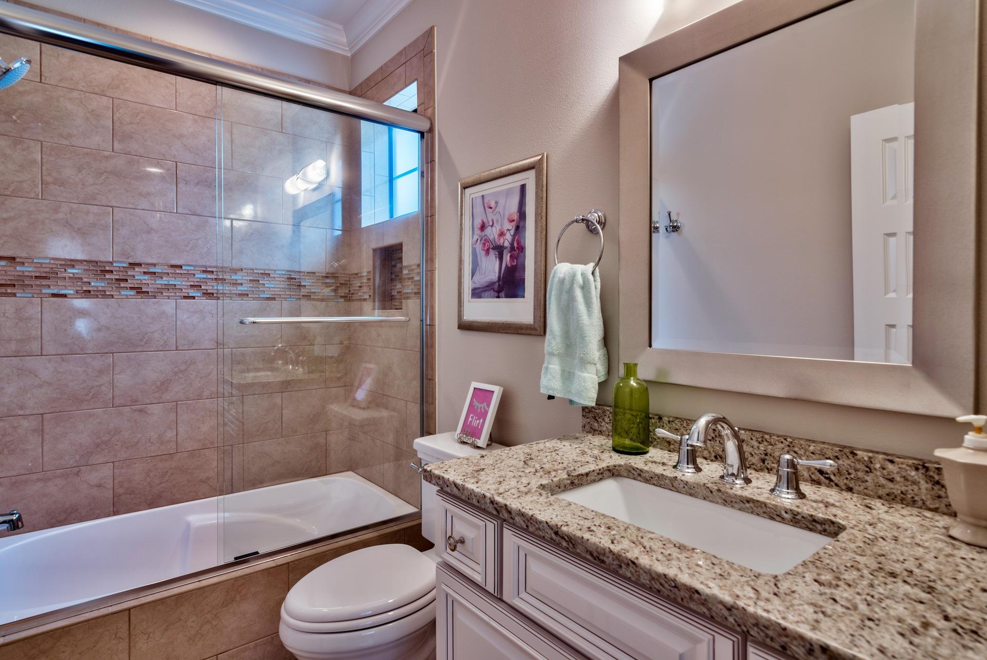 1976 Baytowne Loop Miramar Beach, FL 32550 - Photo 20 of 23 a bathroom with a granite countertop sink toilet a mirror a vanity and shower