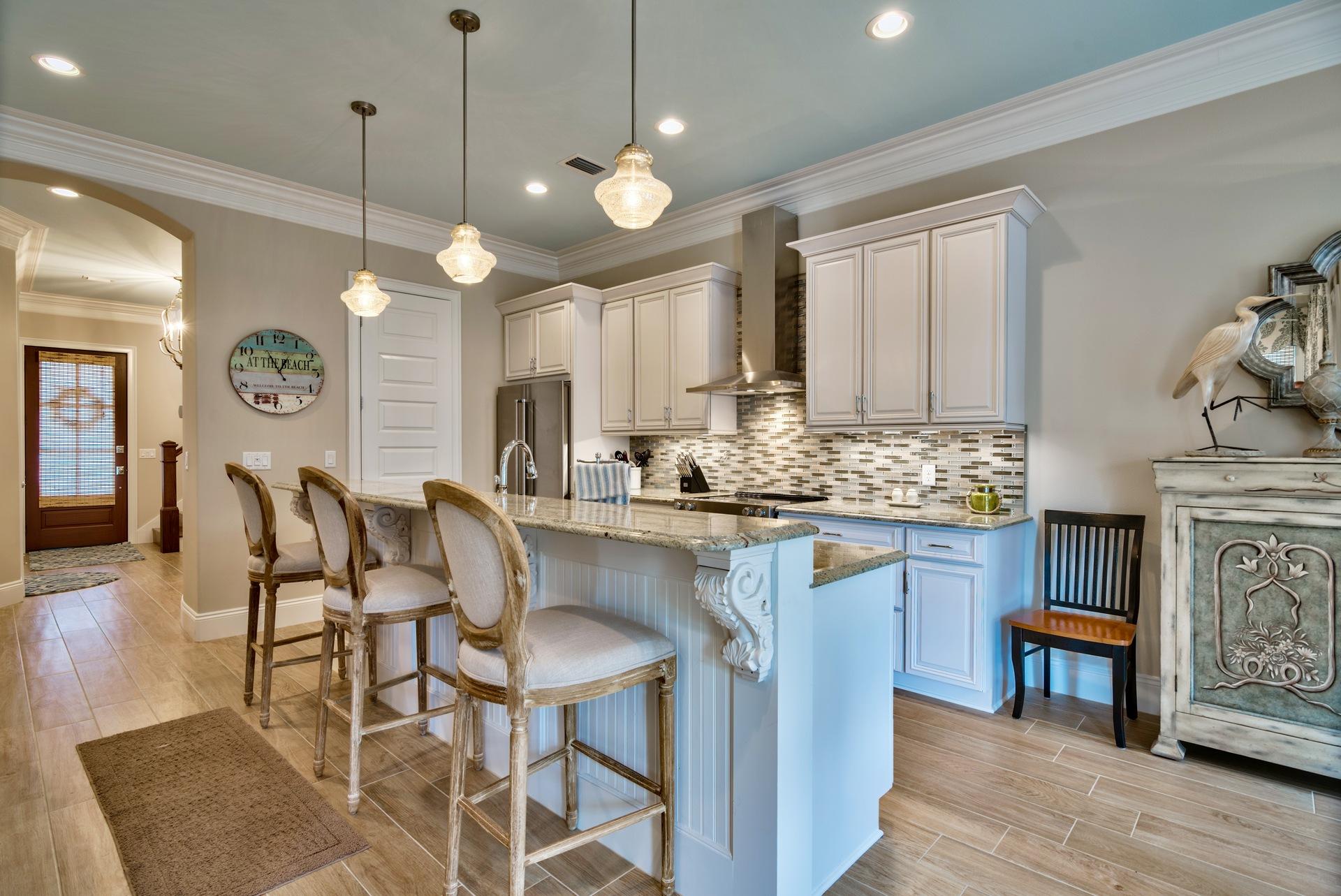 1976 Baytowne Loop Miramar Beach, FL 32550 - Photo 7 of 23 a kitchen with cabinets a counter and chairs in it