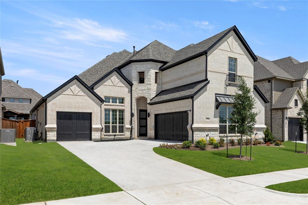 1724 Ruby Way Rockwall, TX 75087 - Photo 1 of 29 a front view of a house with a yard and garage