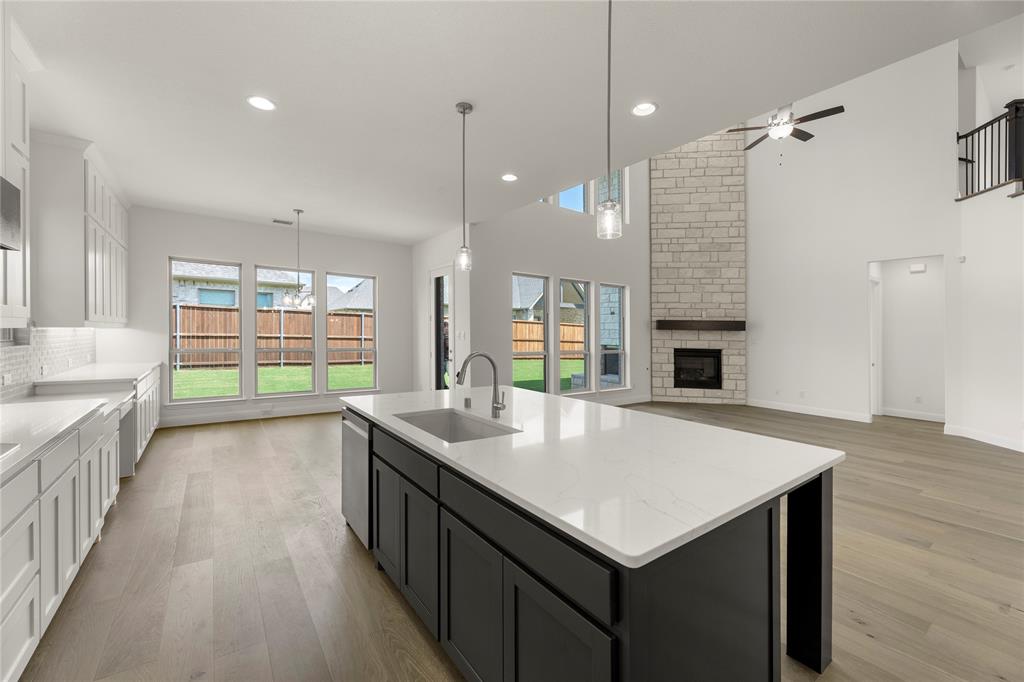 1724 Ruby Way Rockwall, TX 75087 - Photo 11 of 29 an open kitchen with a sink and breakfast area