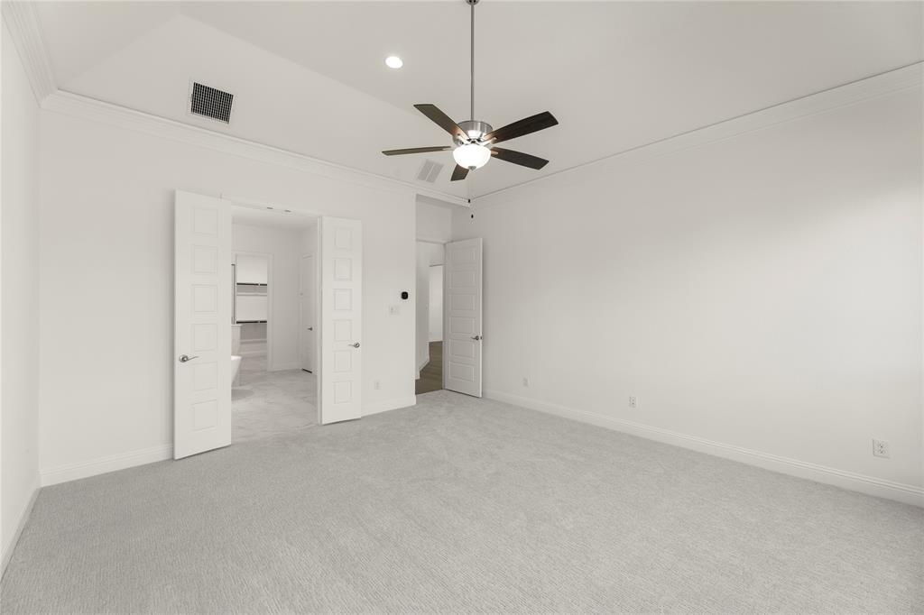 1724 Ruby Way Rockwall, TX 75087 - Photo 14 of 29 an empty room with a ceiling fan and a view of a bathroom