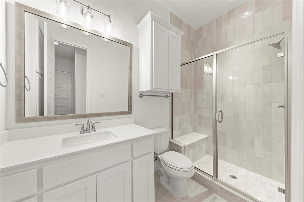 1724 Ruby Way Rockwall, TX 75087 - Photo 22 of 29 a bathroom with a sink a toilet and shower
