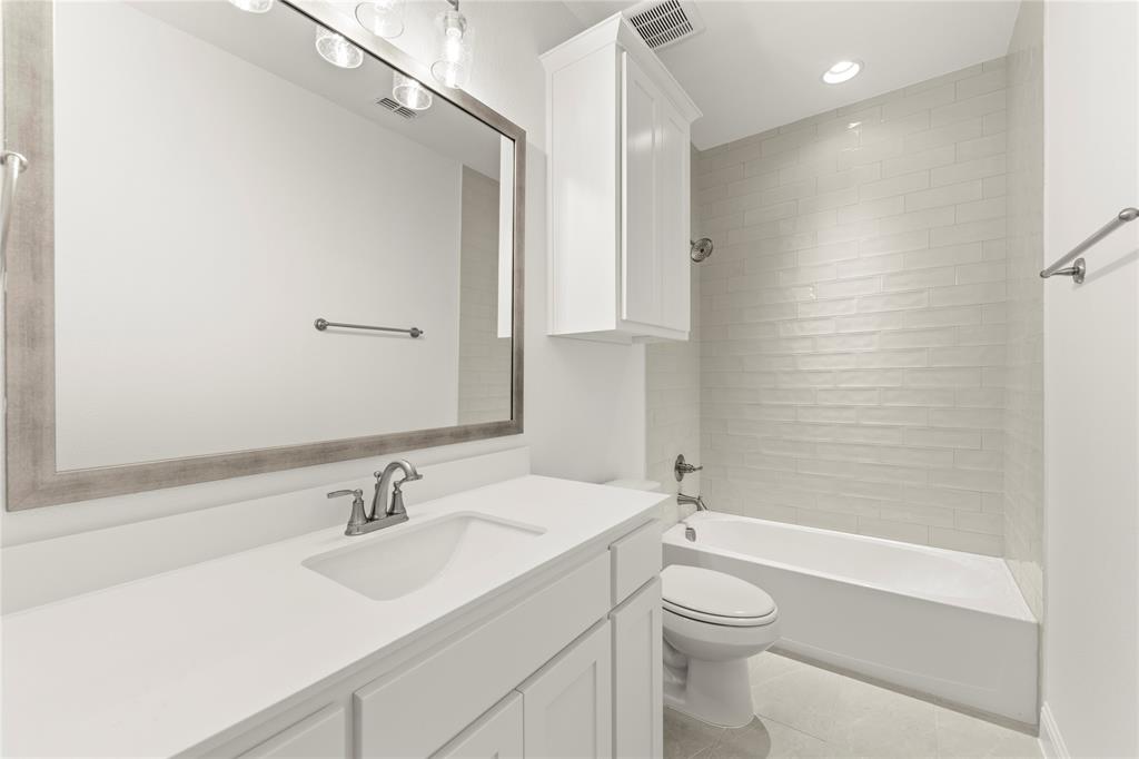 1724 Ruby Way Rockwall, TX 75087 - Photo 23 of 29 a bathroom with a sink a toilet and shower