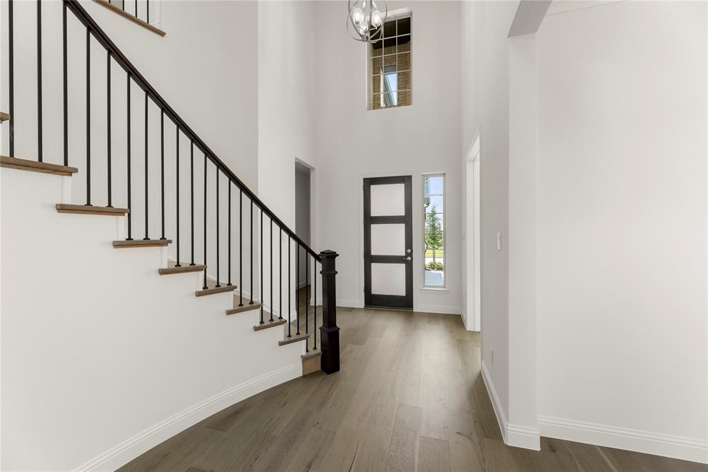 1724 Ruby Way Rockwall, TX 75087 - Photo 3 of 29 a view of a hallway with wooden floor and staircase