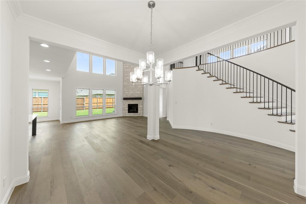 1724 Ruby Way Rockwall, TX 75087 - Photo 6 of 29 a view of a room with wooden floor chandelier and windows