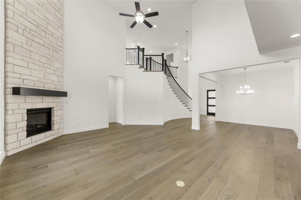 1724 Ruby Way Rockwall, TX 75087 - Photo 8 of 29 a view of empty room with wooden floor and fireplace