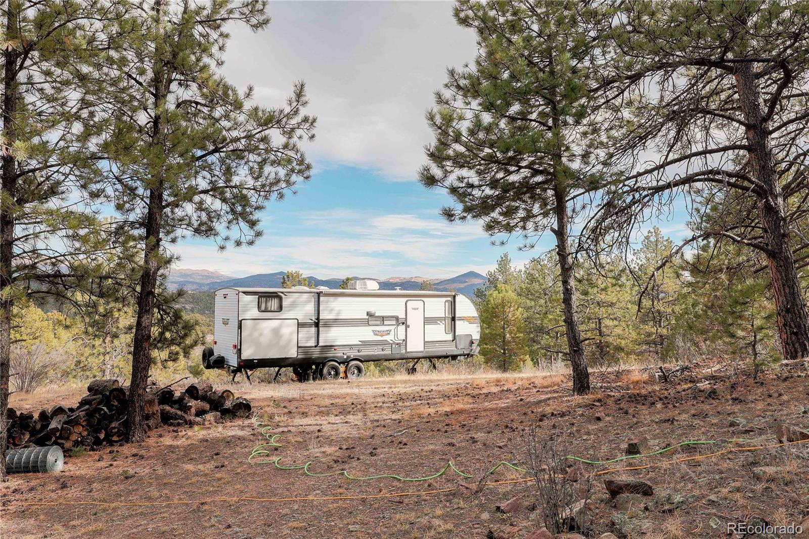 0 Twinkle Road Guffey, CO 80820 - Photo 7 of 24 a front view of a house with a tree in it