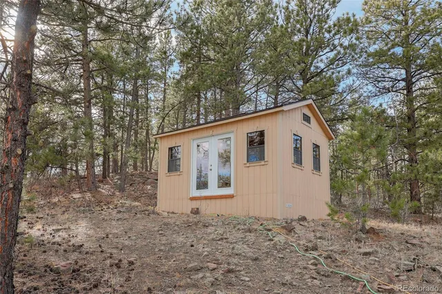 a view of a trees with barn in the background