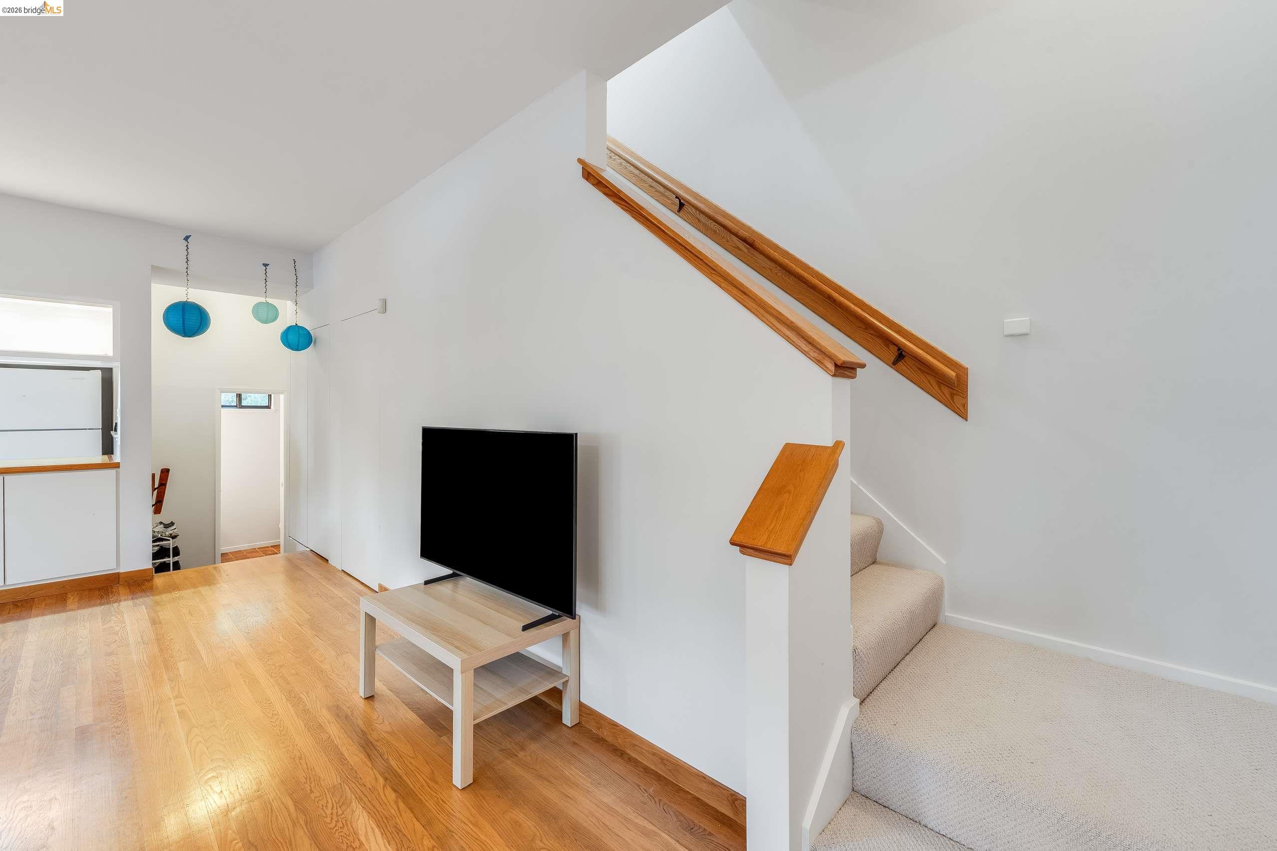 2316 Blake Street, Unit A Berkeley, CA 94704 - Photo 19 of 30 Living room with stairway and light wood-style flooring