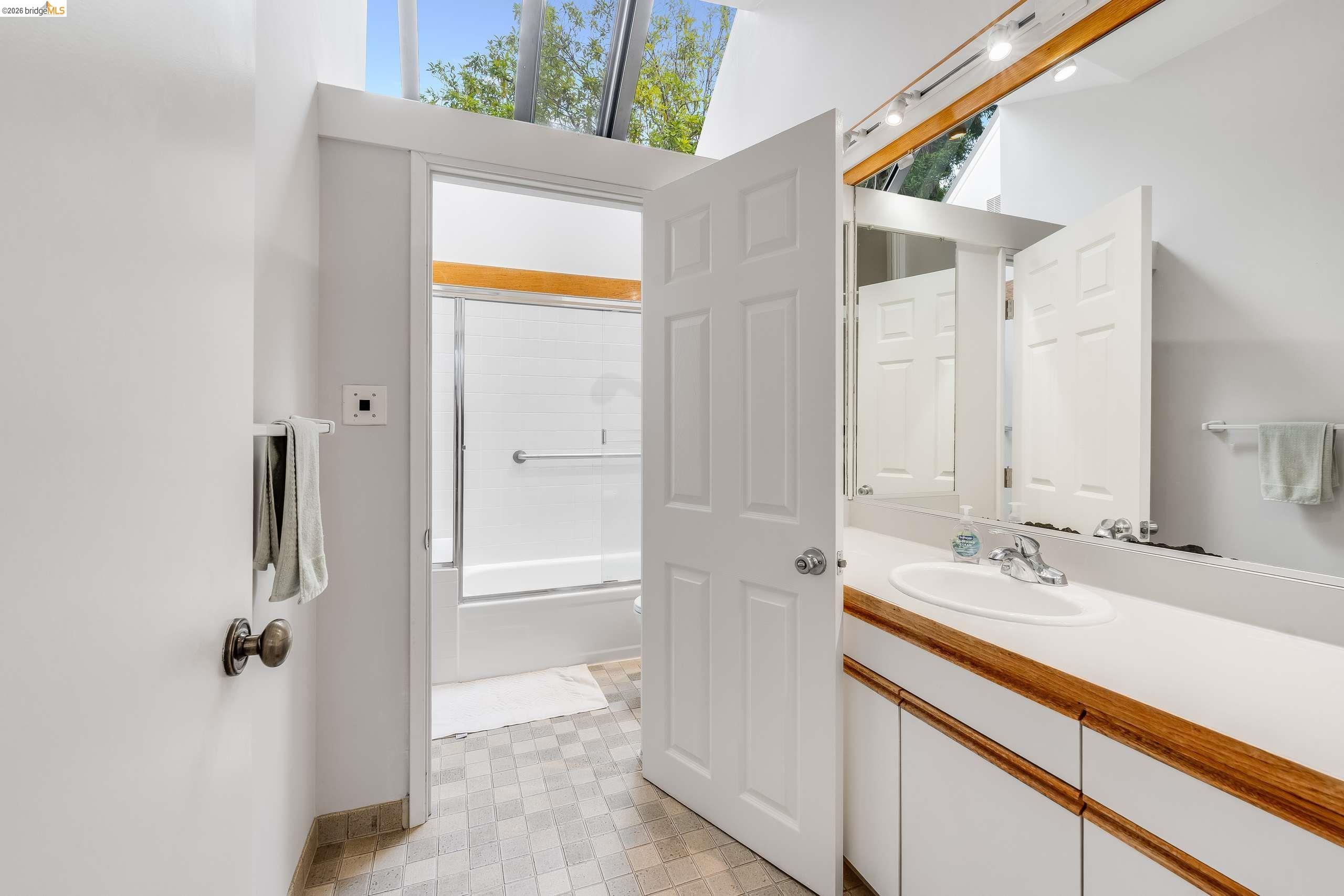 2316 Blake Street, Unit A Berkeley, CA 94704 - Photo 20 of 30 Bathroom with vanity, shower / bath combination with glass door, and light floors