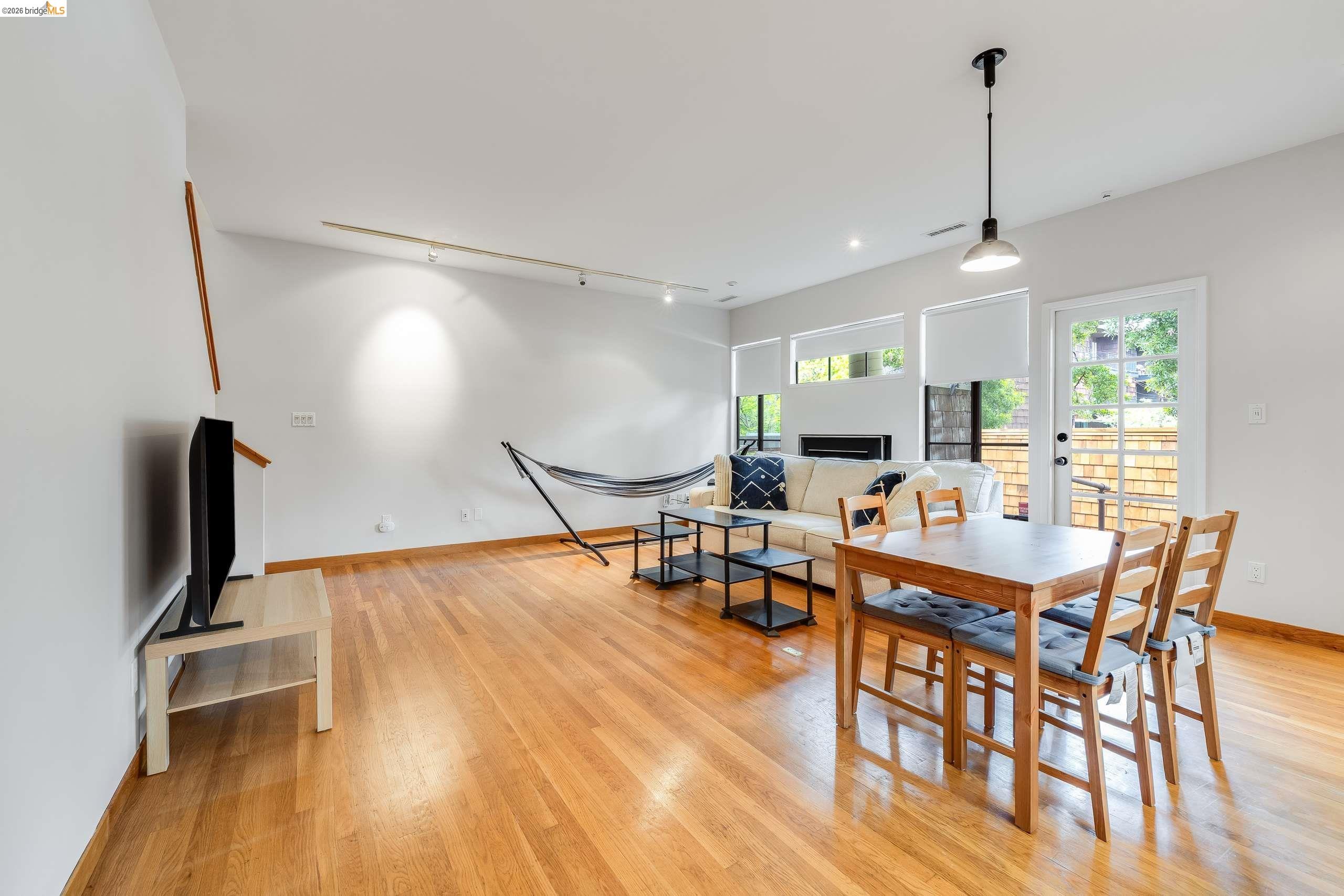 2316 Blake Street, Unit A Berkeley, CA 94704 - Photo 5 of 30 Dining space featuring track lighting, light wood-type flooring, and a fireplace