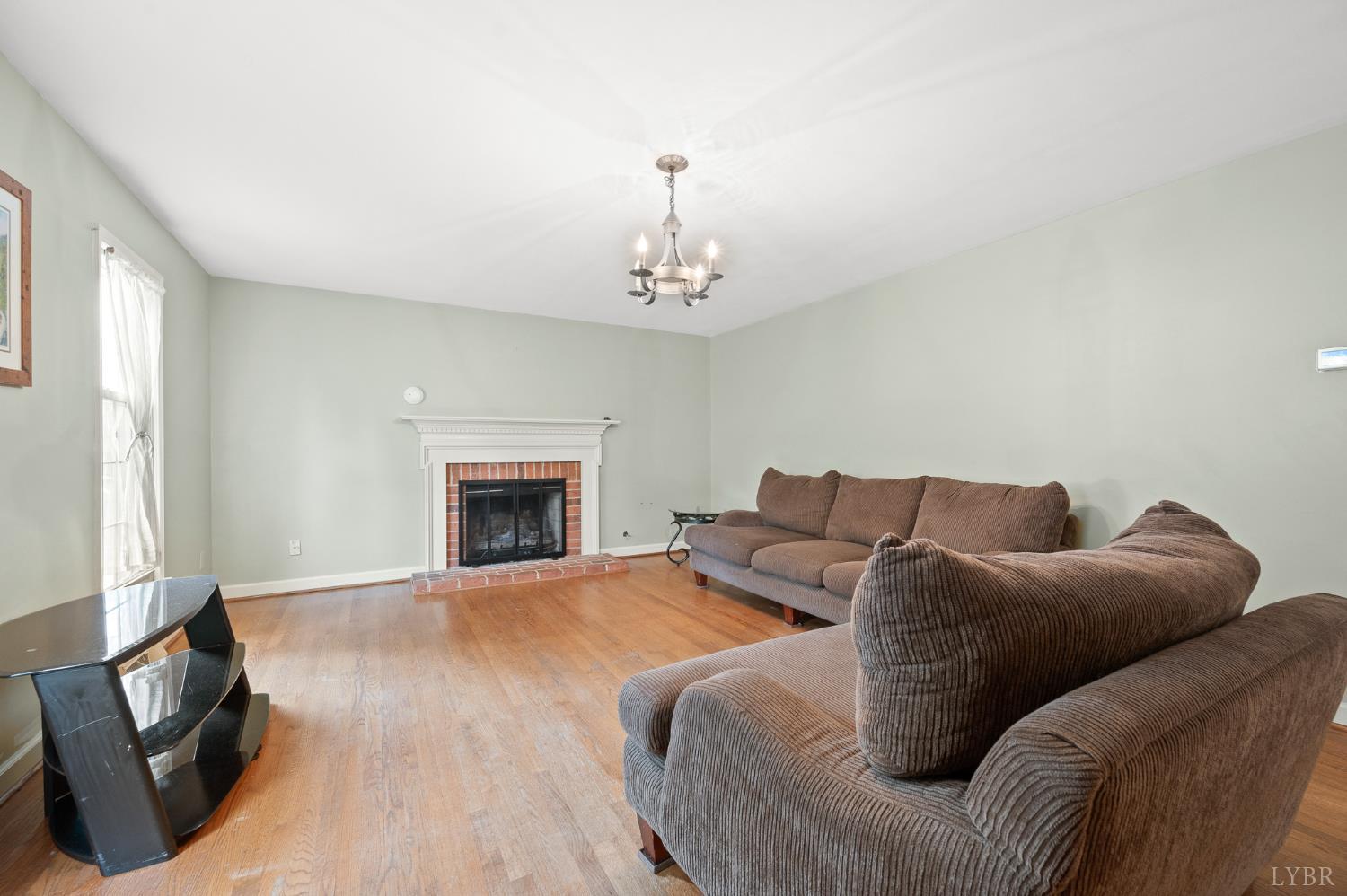 111 East Otter Ridge Drive Goode, VA 24556 - Photo 11 of 62 a living room with furniture a fireplace and a chandelier