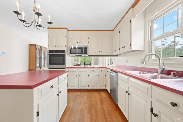 a spacious bathroom with a granite countertop sink and a refrigerator