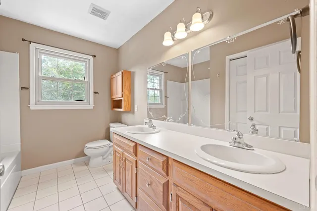 a view of a livingroom with wooden floor and a ceiling fan