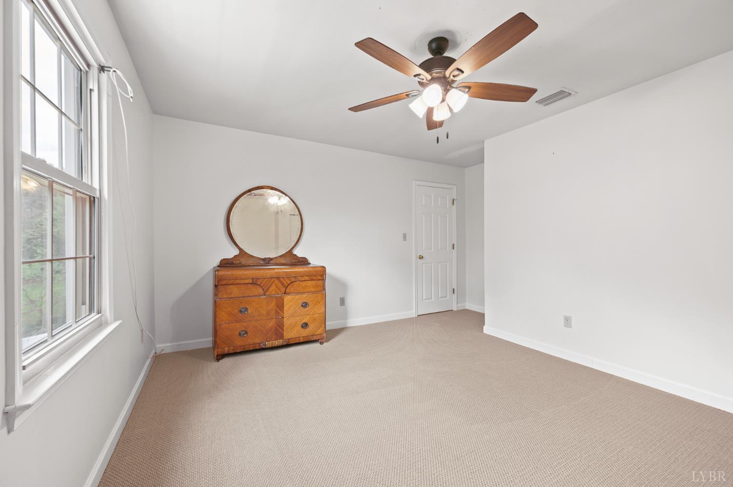 111 East Otter Ridge Drive Goode, VA 24556 - Photo 34 of 62 an empty room with windows and ceiling fan