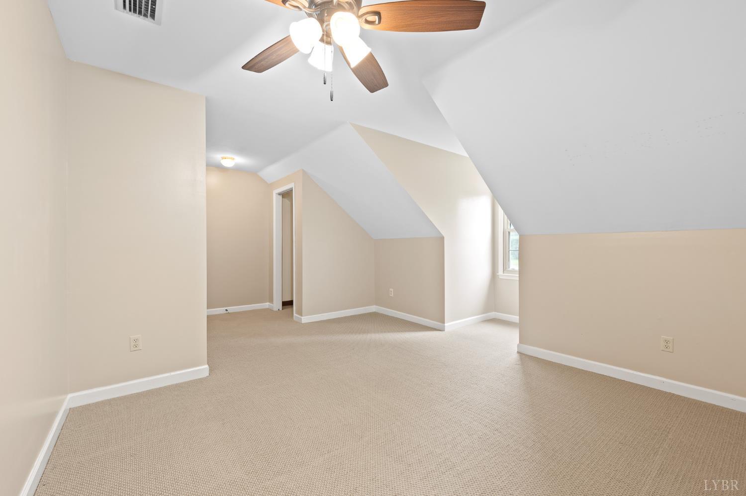 111 East Otter Ridge Drive Goode, VA 24556 - Photo 36 of 62 an empty room with a chandelier fan and windows
