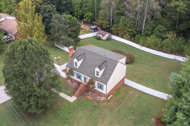 an aerial view of a house with a yard