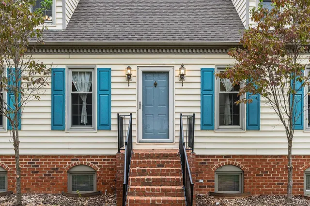 a view of front door with wooden floor and stairs