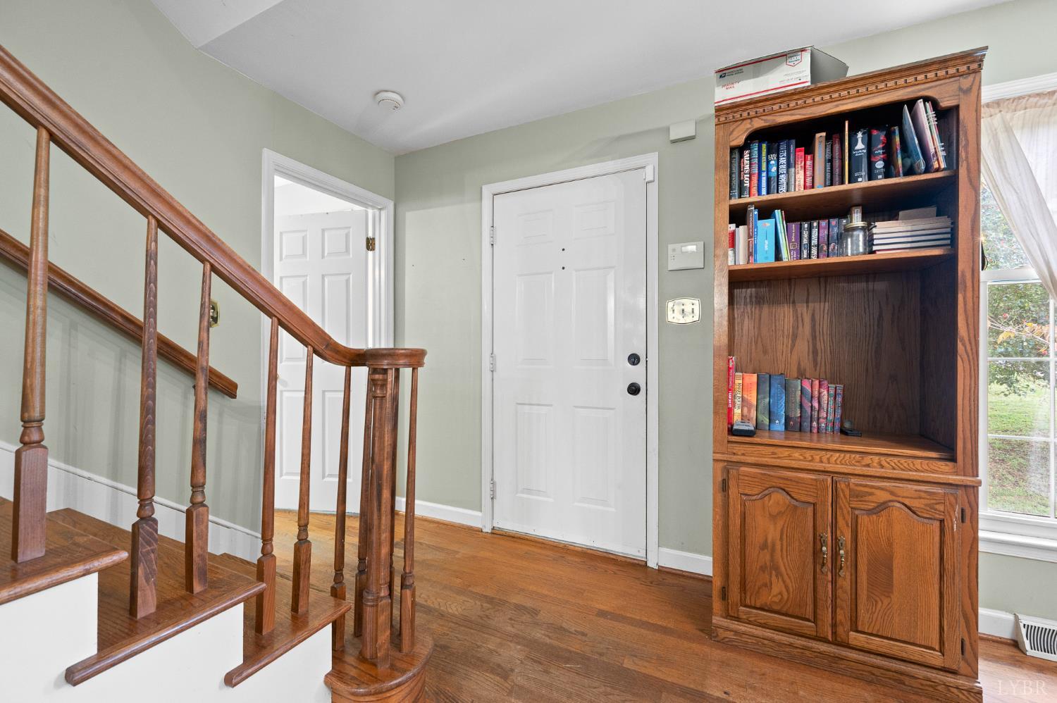 111 East Otter Ridge Drive Goode, VA 24556 - Photo 10 of 62 a view of front door with wooden floor and stairs