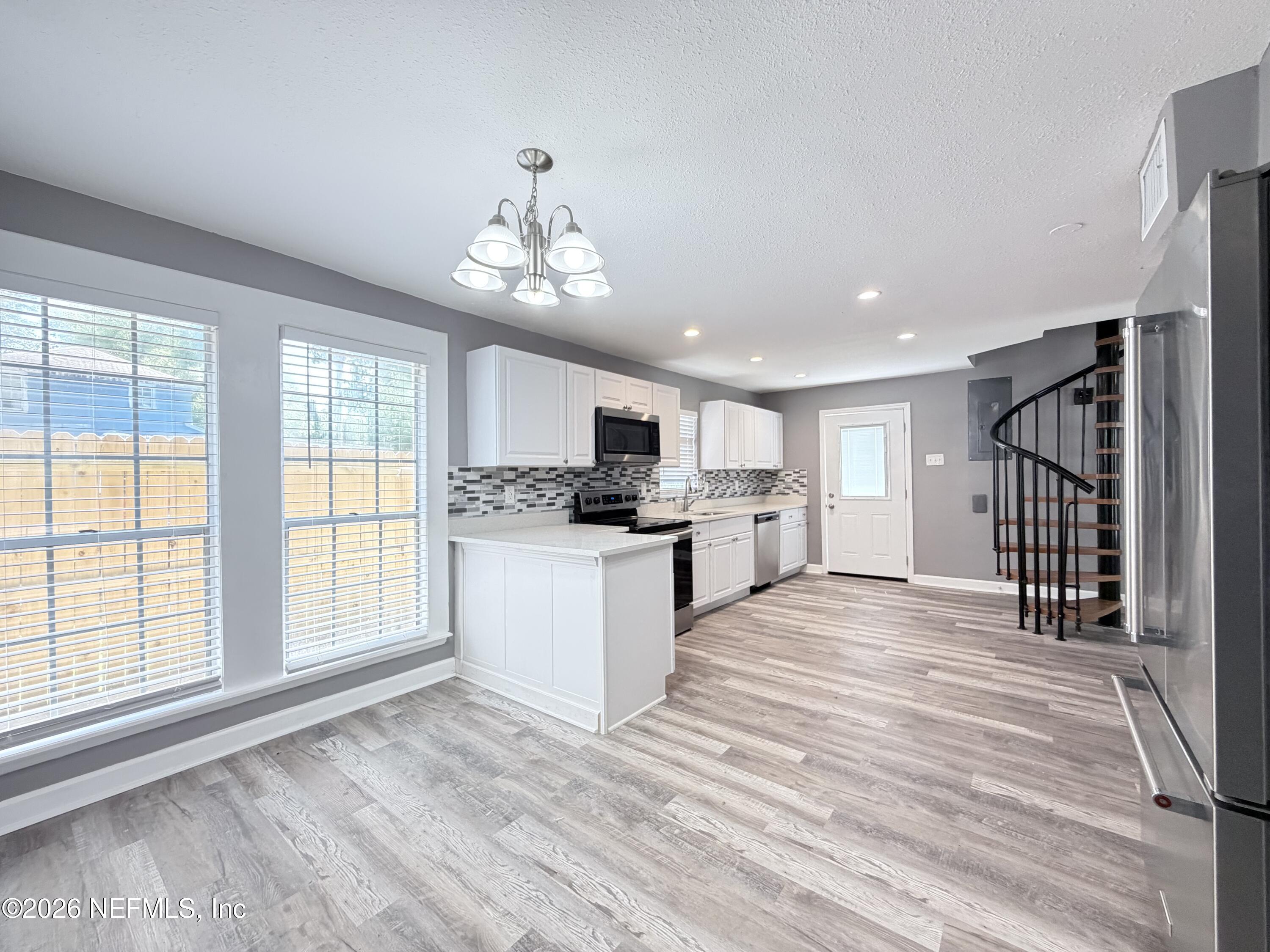 5336 Cruz Road Jacksonville, FL 32207 - Photo 9 of 29 a view of a kitchen with microwave and stove