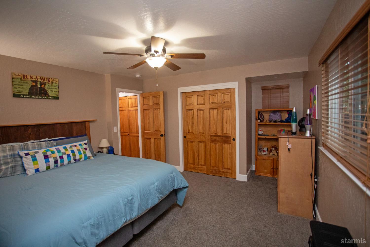 2569 Alma Avenue South Lake Tahoe, CA 96150 - Photo 16 of 35 a bedroom with a bed and a chandelier