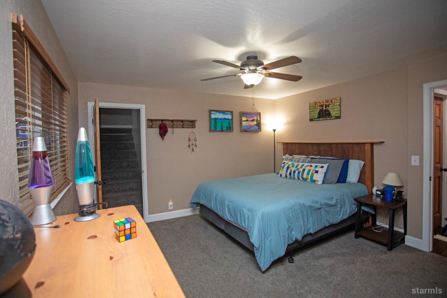 2569 Alma Avenue South Lake Tahoe, CA 96150 - Photo 17 of 35 a bedroom with a bed gym equipment and a baby crib