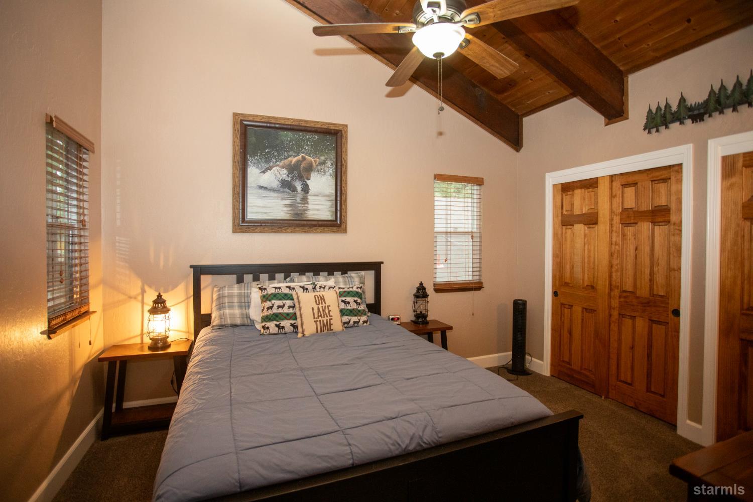 2569 Alma Avenue South Lake Tahoe, CA 96150 - Photo 23 of 35 a bedroom with a bed and a chandelier