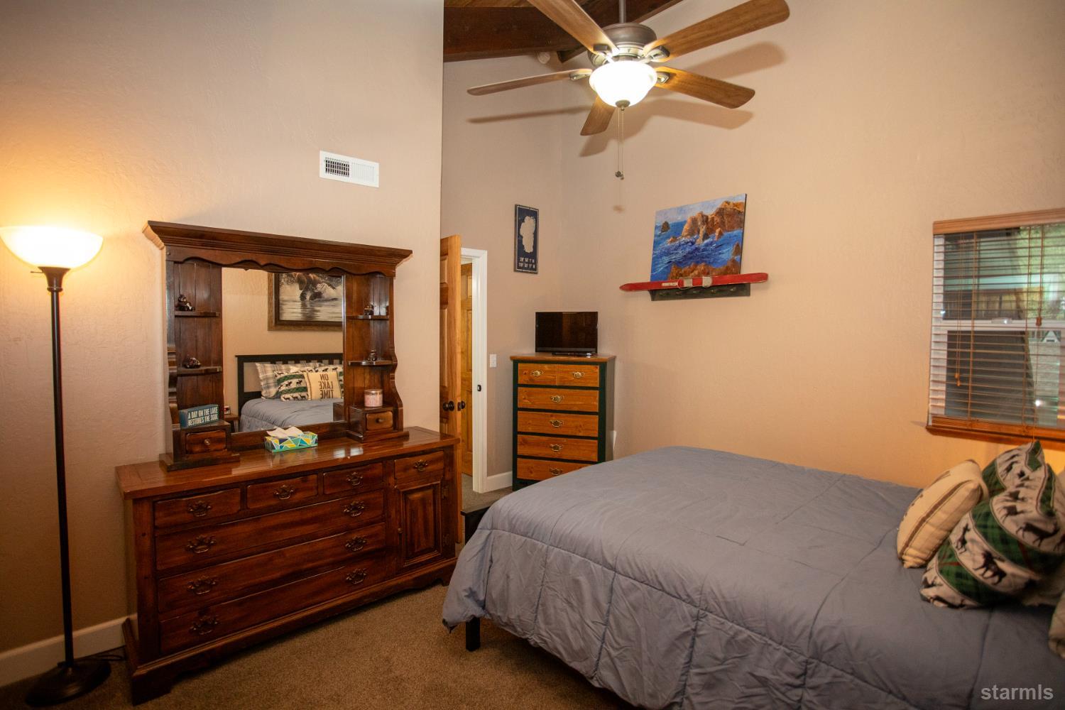 2569 Alma Avenue South Lake Tahoe, CA 96150 - Photo 25 of 35 a bedroom with a bed and a dresser