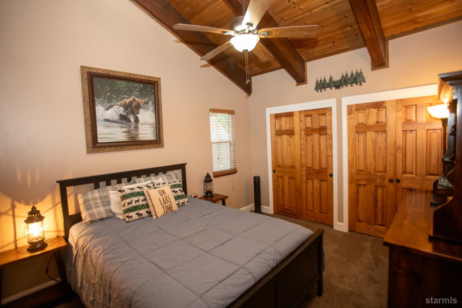 2569 Alma Avenue South Lake Tahoe, CA 96150 - Photo 26 of 35 a bedroom with a bed and a chandelier