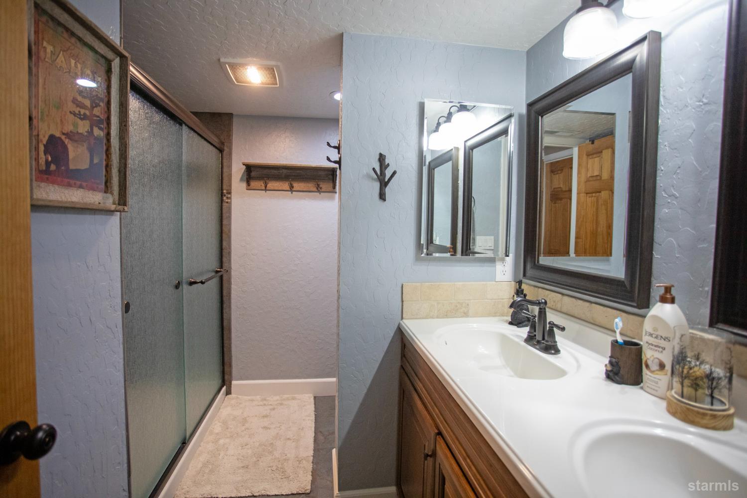 2569 Alma Avenue South Lake Tahoe, CA 96150 - Photo 27 of 35 a bathroom with a sink double vanity and a mirror