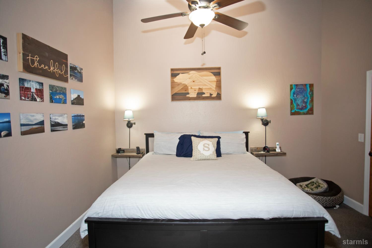 2569 Alma Avenue South Lake Tahoe, CA 96150 - Photo 32 of 35 a bedroom with a bed and a chandelier