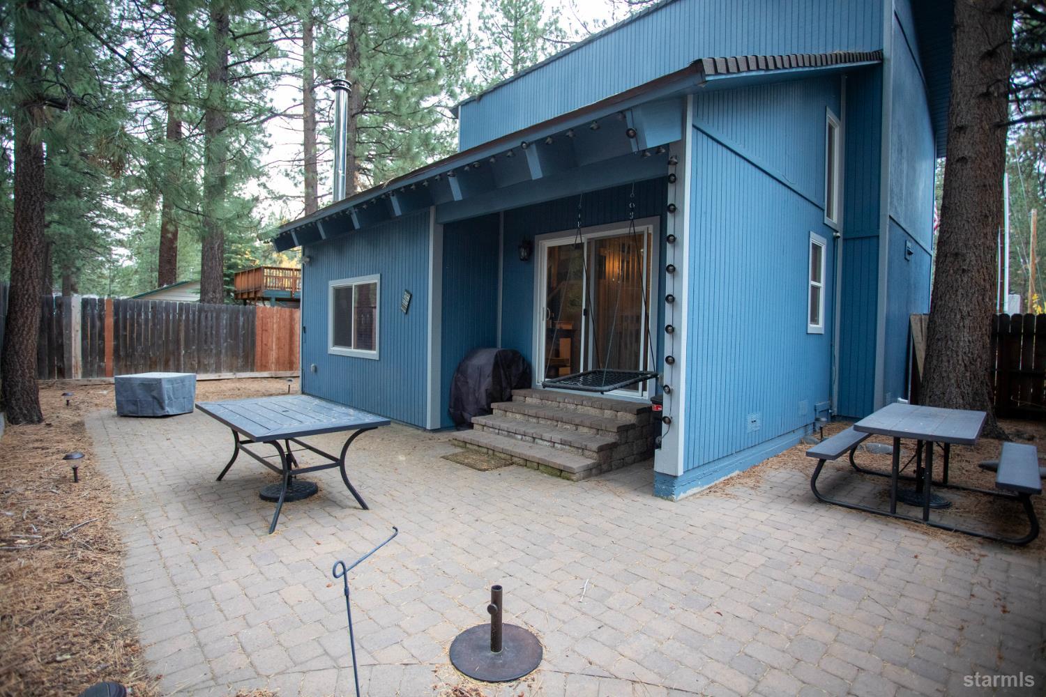 2569 Alma Avenue South Lake Tahoe, CA 96150 - Photo 33 of 35 a view of a backyard with a patio table and chairs